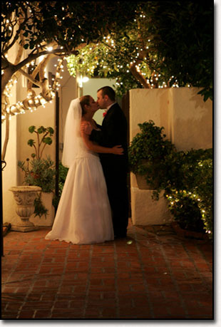 Bride and Groom Kiss in twinkly lights